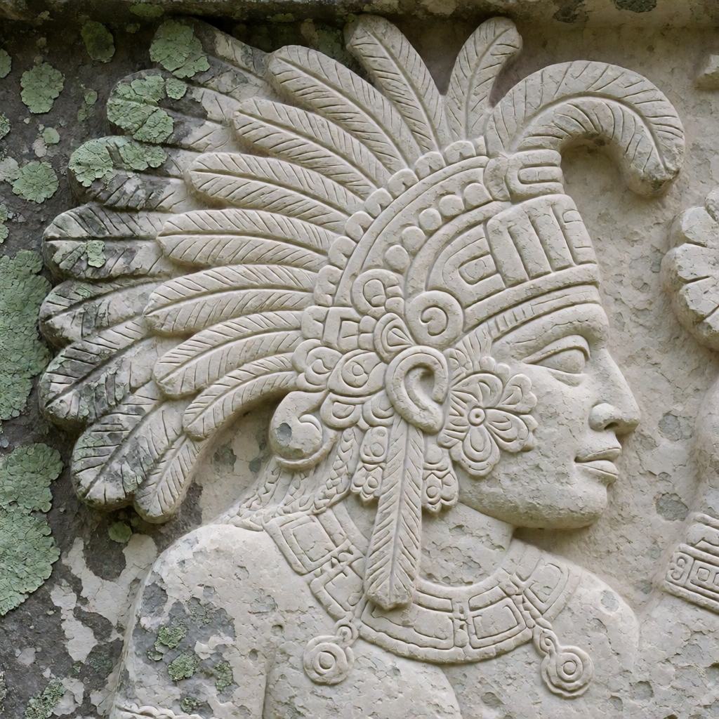 Maya limestone relief panel showing a profile figure in a feathered headdress